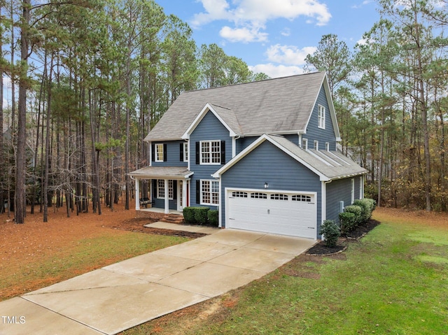 view of front of home featuring a porch, a garage, and a front lawn