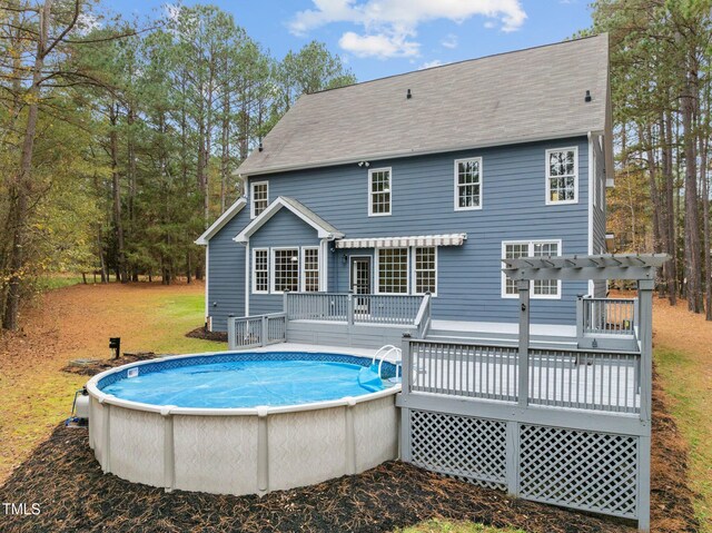 5600 Thornburg Dr, Wake Forest, NC 27587 - back of house featuring a deck, a pergola, an outdoor pool, and a shingled roof
