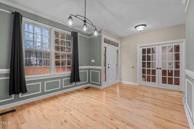 5600 Thornburg Dr, Wake Forest, NC 27587 - unfurnished dining area with french doors, wood finished floors, ornamental molding, and wainscoting