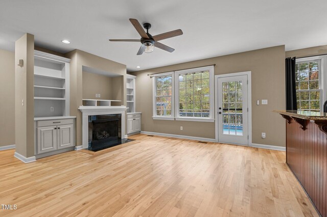 5600 Thornburg Dr, Wake Forest, NC 27587 - unfurnished living room with a ceiling fan, light wood-style floors, baseboards, a fireplace with flush hearth, and recessed lighting