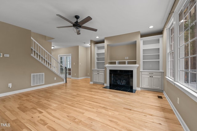 5600 Thornburg Dr, Wake Forest, NC 27587 - unfurnished living room featuring light wood finished floors, baseboards, ceiling fan, a tile fireplace, and recessed lighting