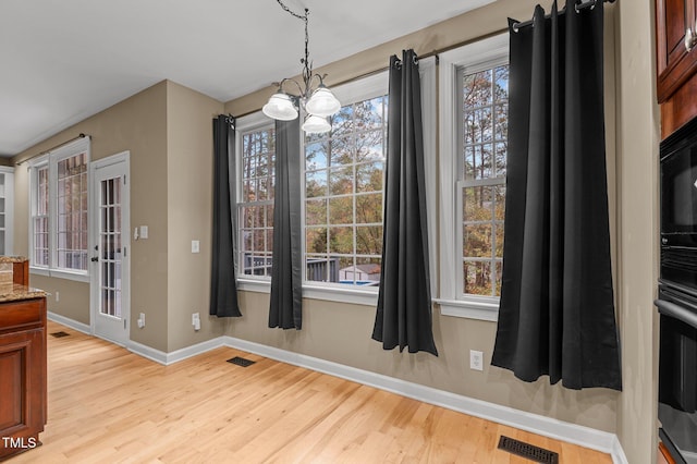 5600 Thornburg Dr, Wake Forest, NC 27587 - unfurnished dining area with light wood finished floors, baseboards, and a chandelier