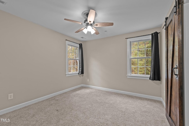 5600 Thornburg Dr, Wake Forest, NC 27587 - carpeted spare room featuring baseboards, a ceiling fan, and a barn door
