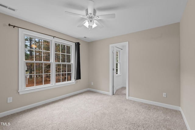 empty room featuring light carpet and ceiling fan