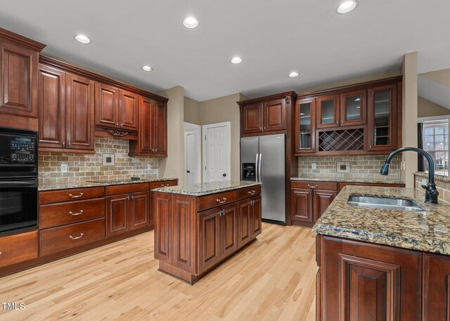 5600 Thornburg Dr, Wake Forest, NC 27587 - kitchen featuring black appliances, a sink, light wood finished floors, tasteful backsplash, and recessed lighting
