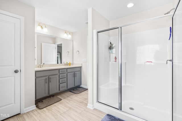 bathroom featuring walk in shower and vanity