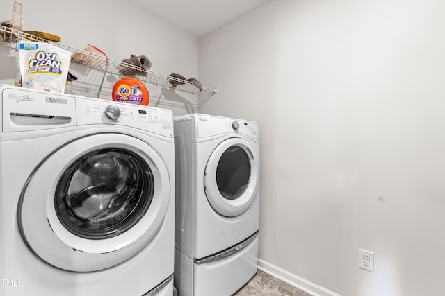 laundry room featuring washing machine and clothes dryer