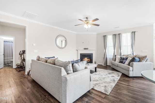 living room featuring ornamental molding, dark wood-type flooring, and ceiling fan