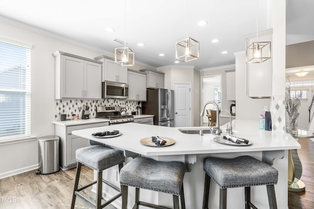 kitchen with gray cabinetry, light wood-type flooring, sink, and stainless steel appliances