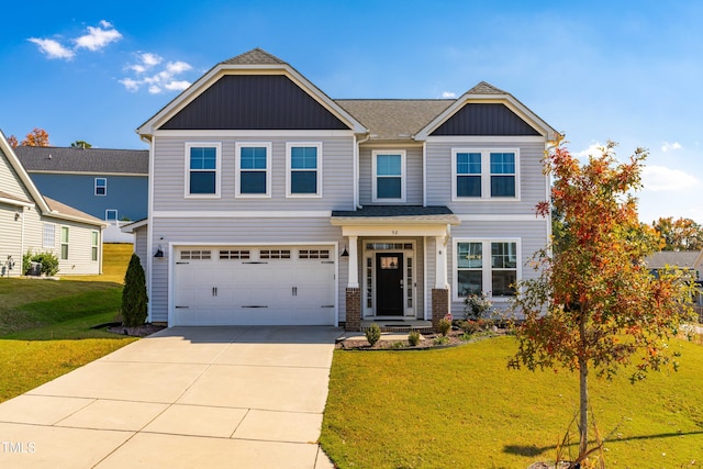 craftsman-style home featuring a front yard and a garage