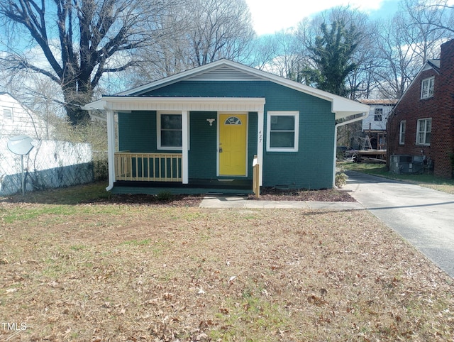 bungalow-style house featuring covered porch and brick siding