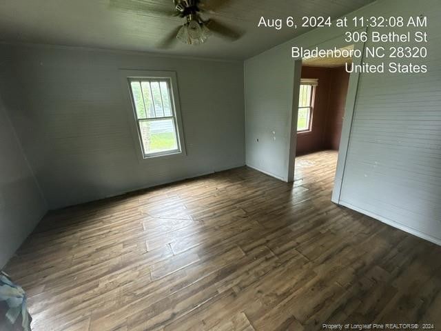 empty room with hardwood / wood-style flooring and ceiling fan