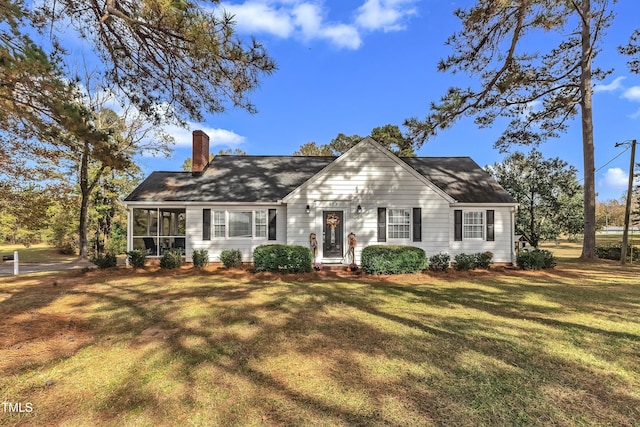 view of front of property featuring a sunroom and a front yard