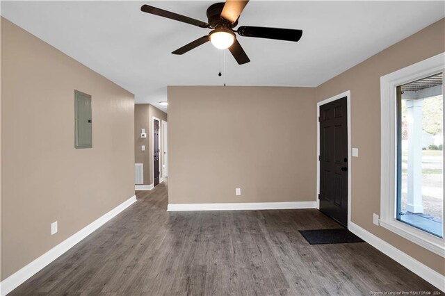 interior space with electric panel, wood-type flooring, and ceiling fan