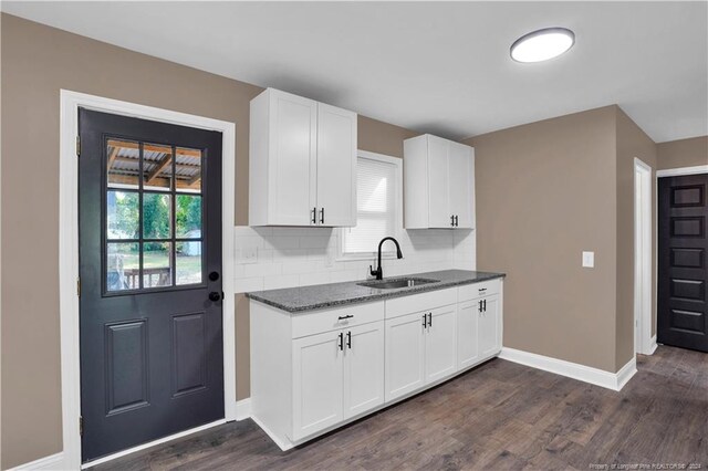 kitchen with dark wood-type flooring, white cabinetry, sink, and plenty of natural light