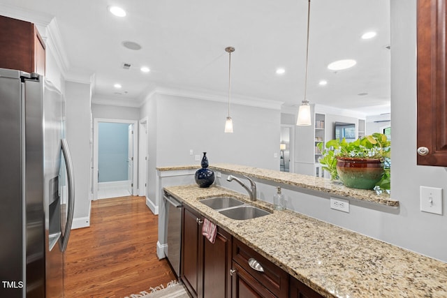 kitchen with sink, appliances with stainless steel finishes, hanging light fixtures, crown molding, and dark hardwood / wood-style flooring