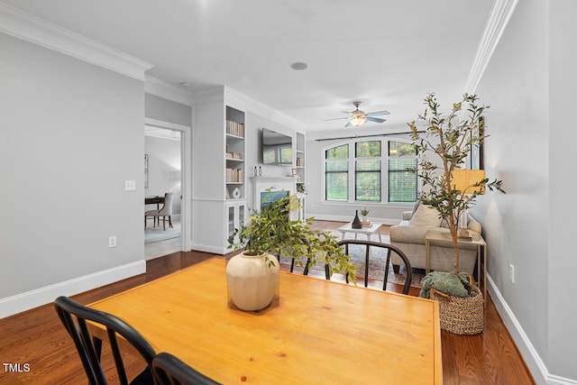 dining area with wood-type flooring, ceiling fan, and crown molding