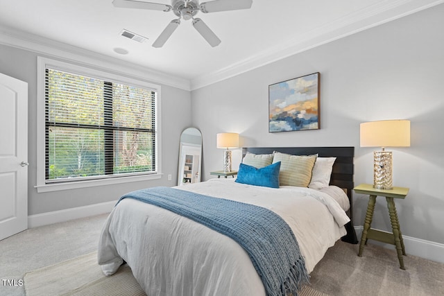 carpeted bedroom with ornamental molding, multiple windows, and ceiling fan