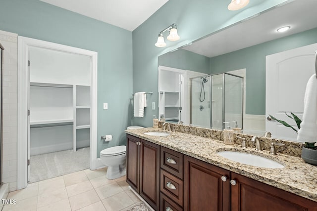 bathroom featuring walk in shower, vanity, toilet, and tile patterned floors