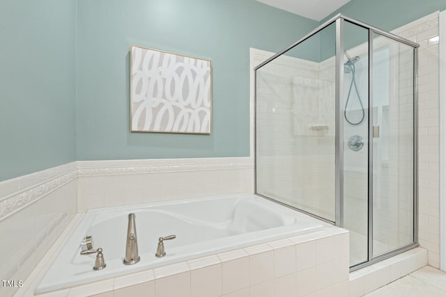 bathroom with shower with separate bathtub and tile patterned floors