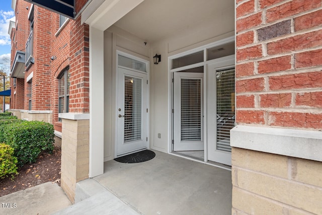 view of exterior entry with a patio