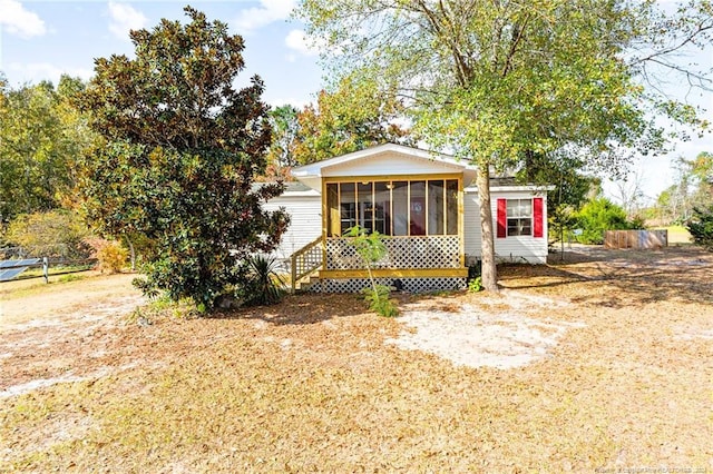 view of front facade with a sunroom