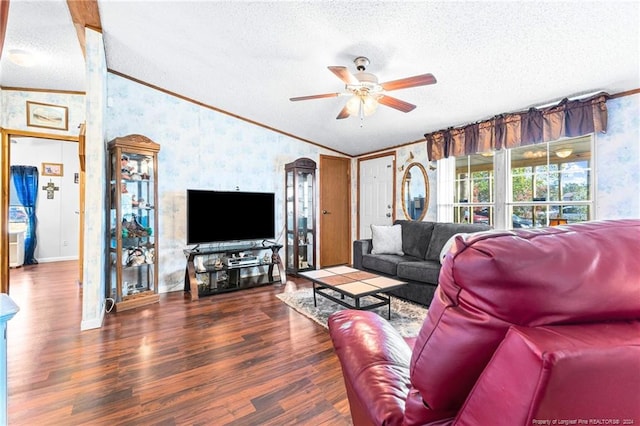 living room with ornamental molding, a textured ceiling, ceiling fan, dark hardwood / wood-style floors, and lofted ceiling