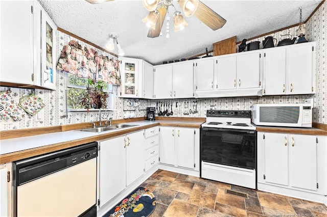 kitchen with white cabinetry, sink, white appliances, and a textured ceiling