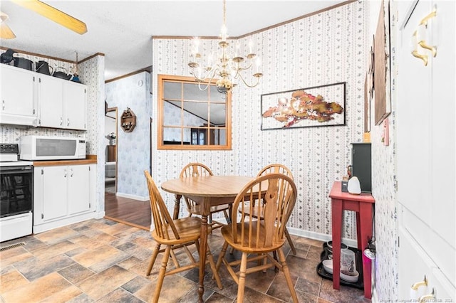 dining space with a chandelier, a textured ceiling, and ornamental molding