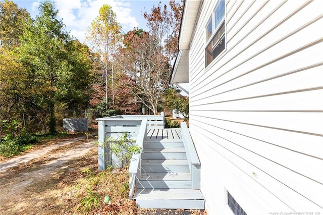 view of property exterior featuring a wooden deck