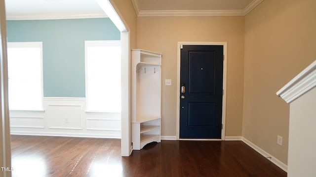 entryway featuring dark wood-type flooring and crown molding