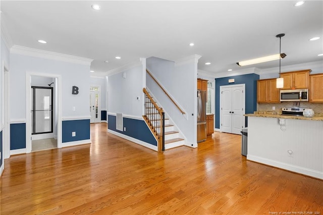 unfurnished living room with ornamental molding and light hardwood / wood-style flooring