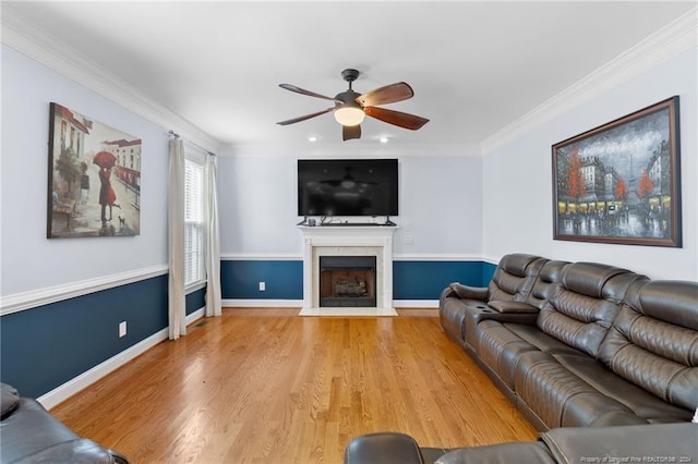 living room with ceiling fan, wood-type flooring, and crown molding