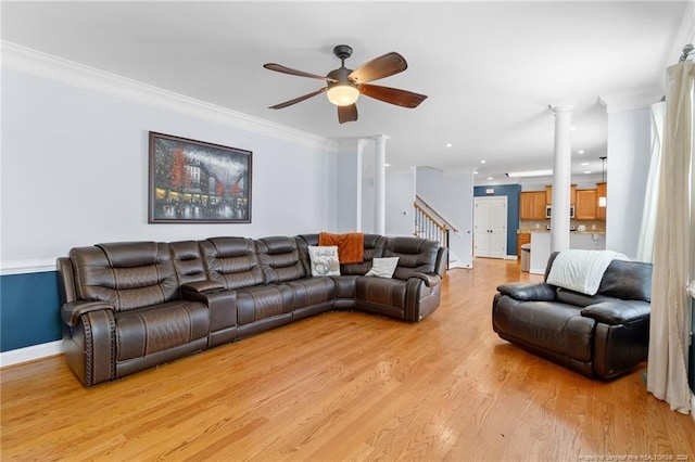 living room with ceiling fan, ornamental molding, and light hardwood / wood-style flooring