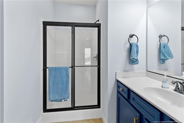 bathroom with vanity and an enclosed shower