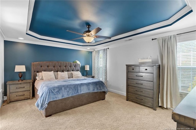 bedroom with crown molding, light carpet, ceiling fan, and a raised ceiling