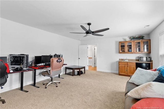 office featuring sink, light carpet, and ceiling fan