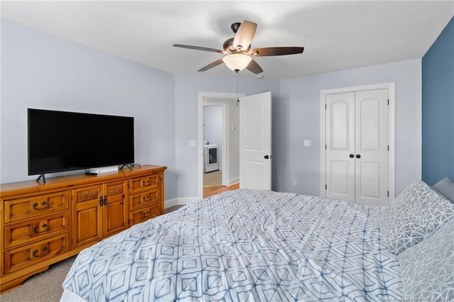 carpeted bedroom with ceiling fan, a closet, and washer / clothes dryer