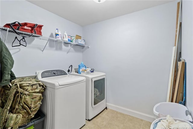 clothes washing area with light tile patterned floors and separate washer and dryer