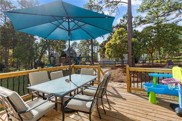 wooden deck featuring a playground