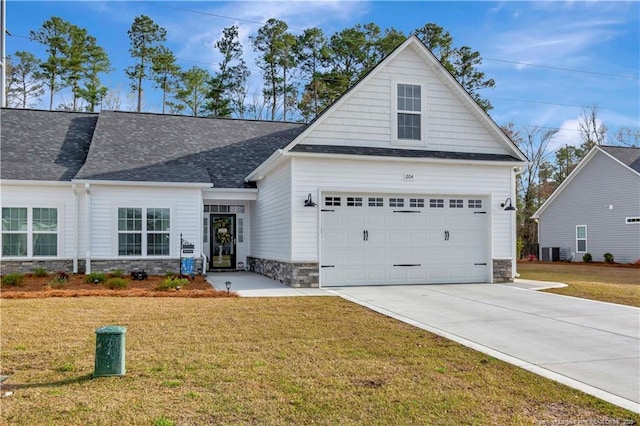 view of front of property featuring a garage and a front lawn