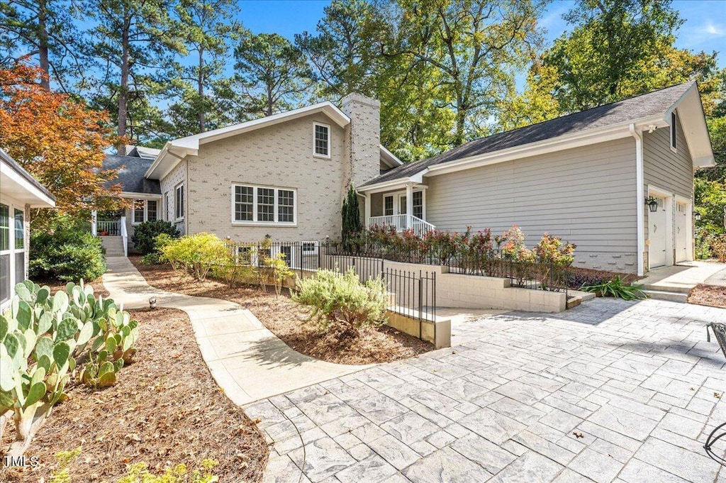 back of house featuring a garage