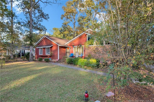 view of side of property with a lawn