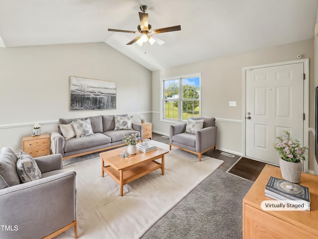 living room with dark colored carpet, lofted ceiling, and ceiling fan