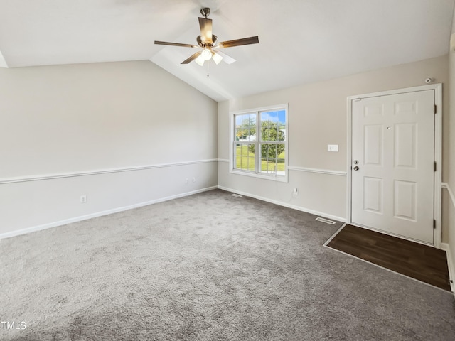 carpeted spare room featuring ceiling fan and vaulted ceiling