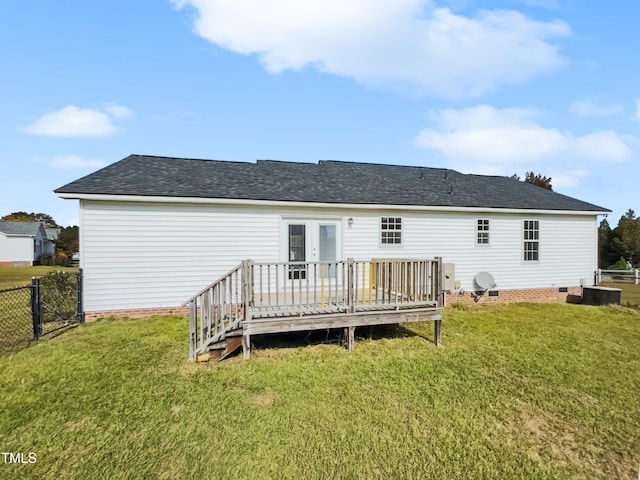 rear view of property with a yard and a deck