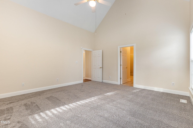 unfurnished bedroom featuring light colored carpet, high vaulted ceiling, and ceiling fan