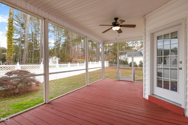 unfurnished sunroom with ceiling fan