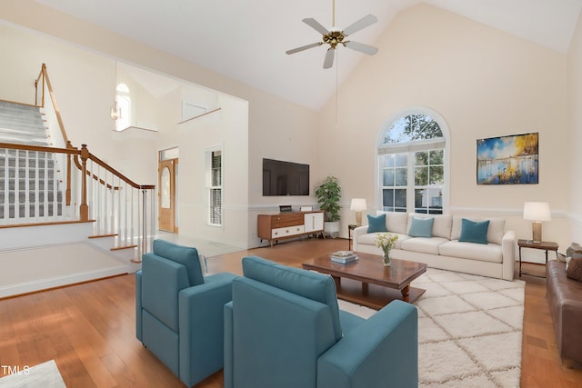 living room featuring ceiling fan, wood-type flooring, and high vaulted ceiling