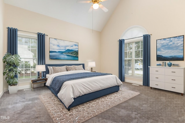 bedroom with high vaulted ceiling, dark carpet, and ceiling fan